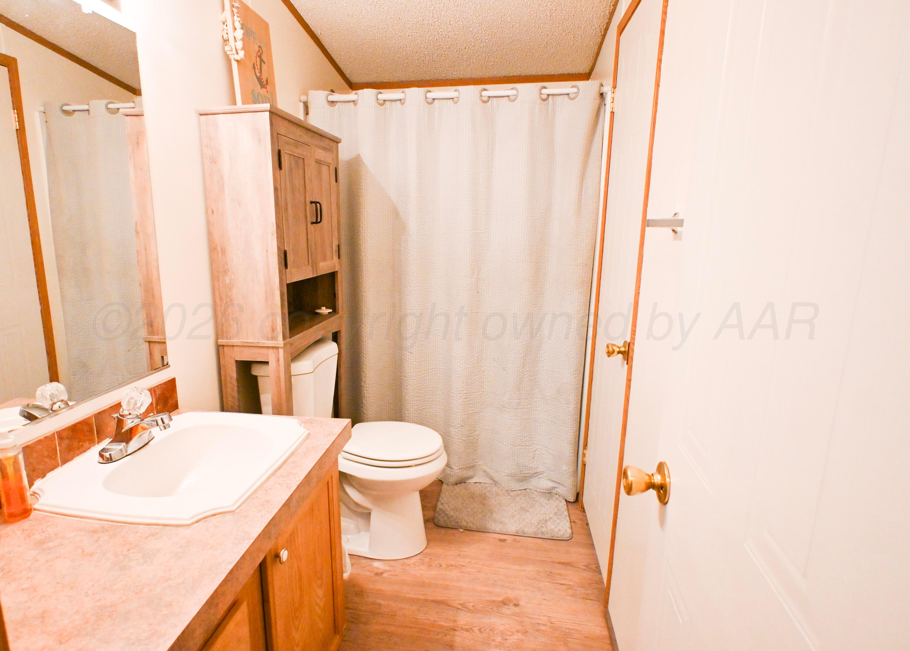314 Cactus Road Borger, TX 79007 - Photo 16 of 28 a bathroom with a sink toilet and shower
