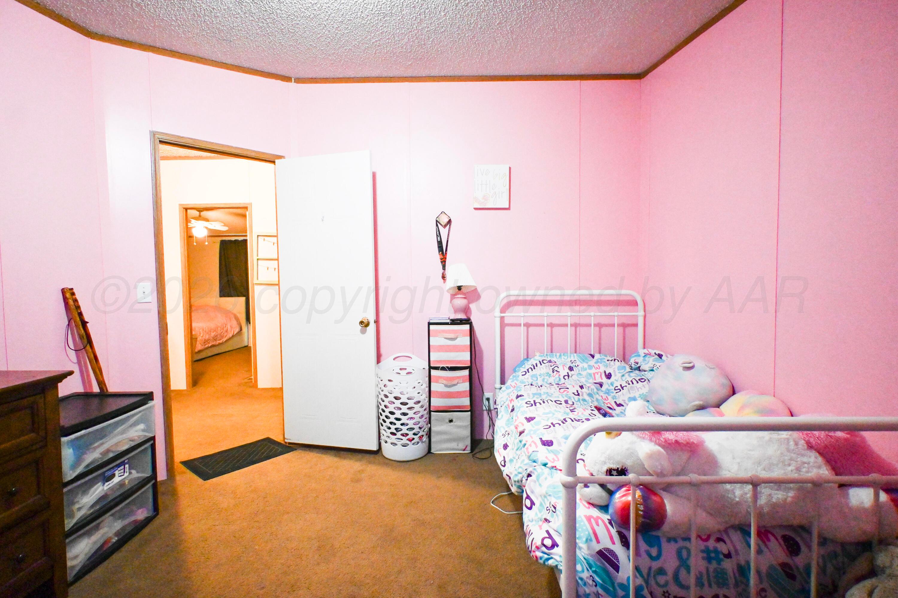 314 Cactus Road Borger, TX 79007 - Photo 17 of 28 a bedroom with a bed and a sink