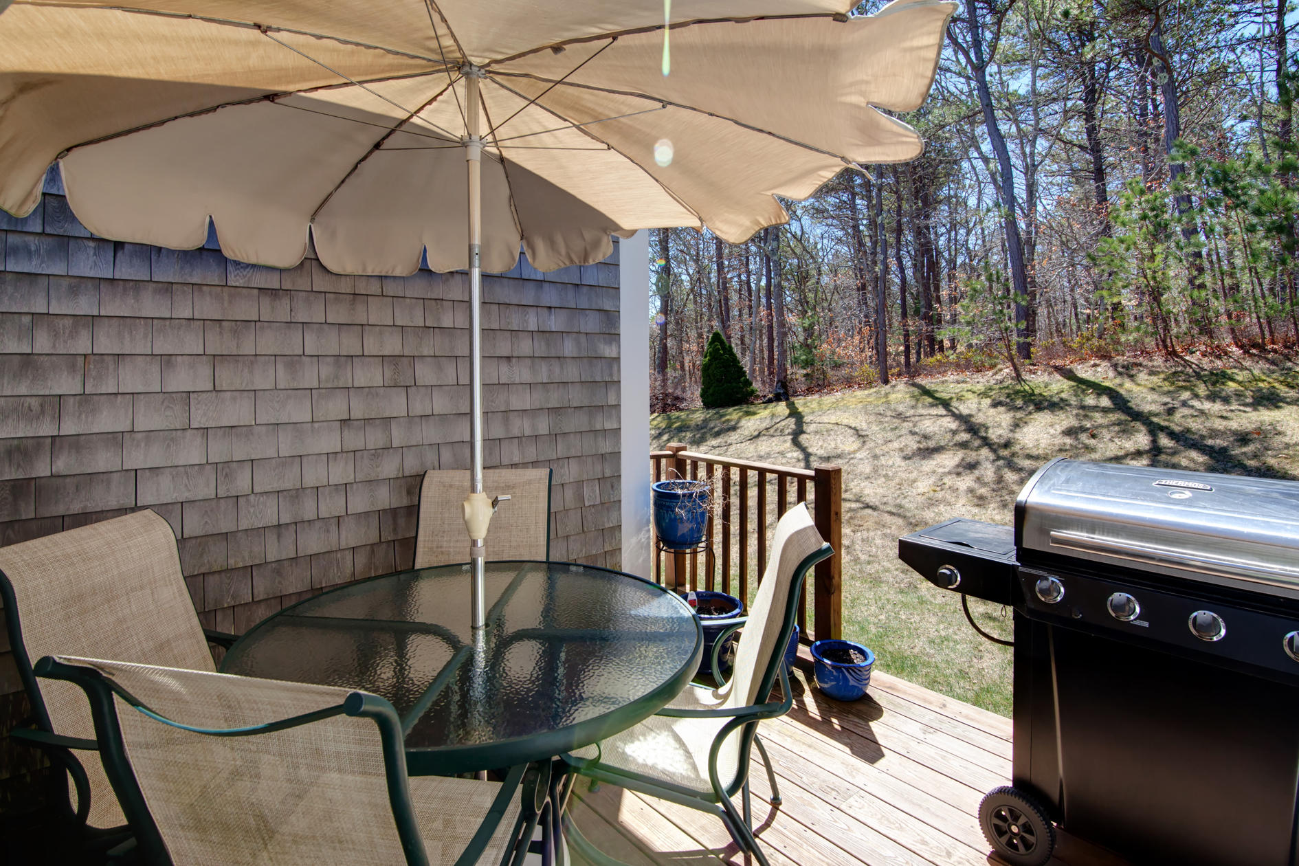 22 Stratford Ridge Mashpee, MA 02649 - Photo 27 of 35 a backyard of a house with barbeque oven table and chairs