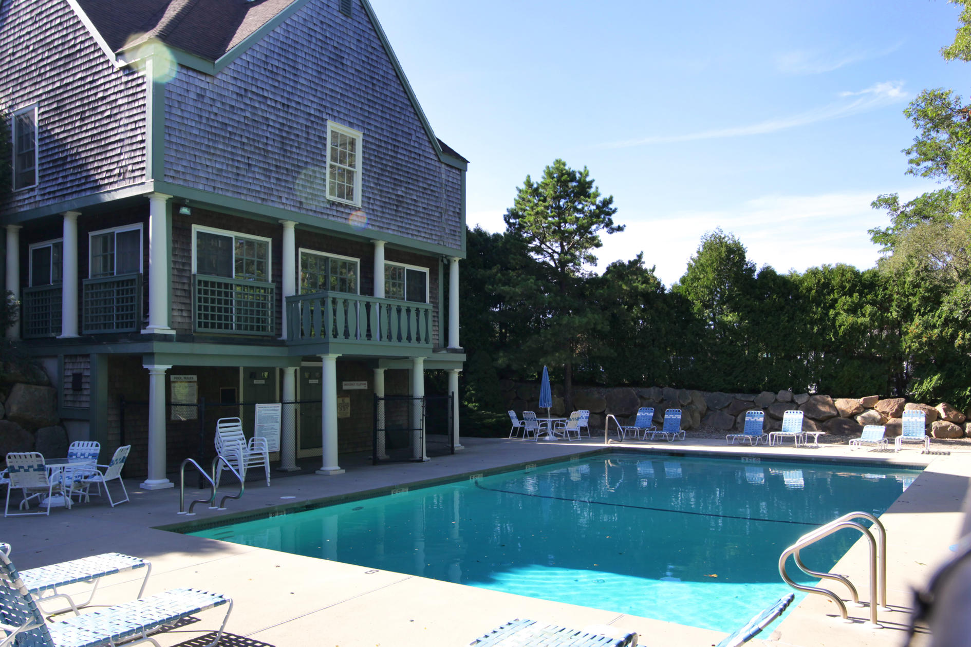 22 Stratford Ridge Mashpee, MA 02649 - Photo 31 of 35 a view of a brick house with a chairs in patio