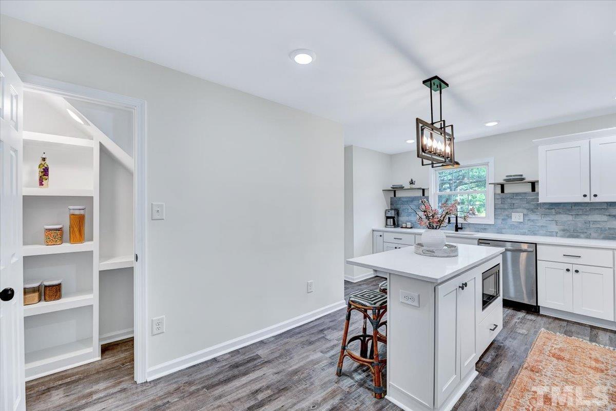 962 Laurel Mill-Centerville Road Louisburg, NC 27549 - Photo 14 of 36 a kitchen with a sink cabinets and wooden floor