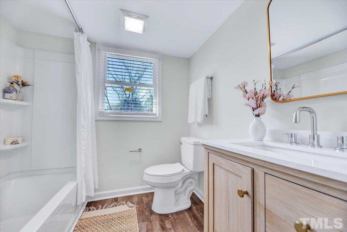 962 Laurel Mill-Centerville Road Louisburg, NC 27549 - Photo 23 of 36 a bathroom with a sink a toilet and bathtub