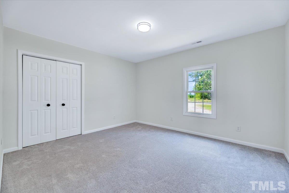 962 Laurel Mill-Centerville Road Louisburg, NC 27549 - Photo 25 of 36 an empty room with windows