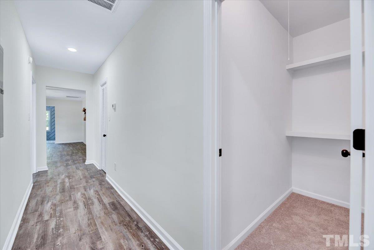 962 Laurel Mill-Centerville Road Louisburg, NC 27549 - Photo 27 of 36 a view of a hallway with wooden floor