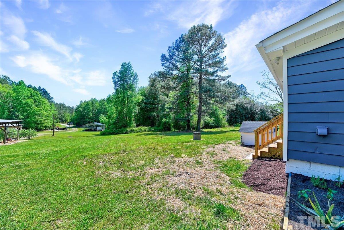 962 Laurel Mill-Centerville Road Louisburg, NC 27549 - Photo 33 of 36 a view of a backyard with wooden fence