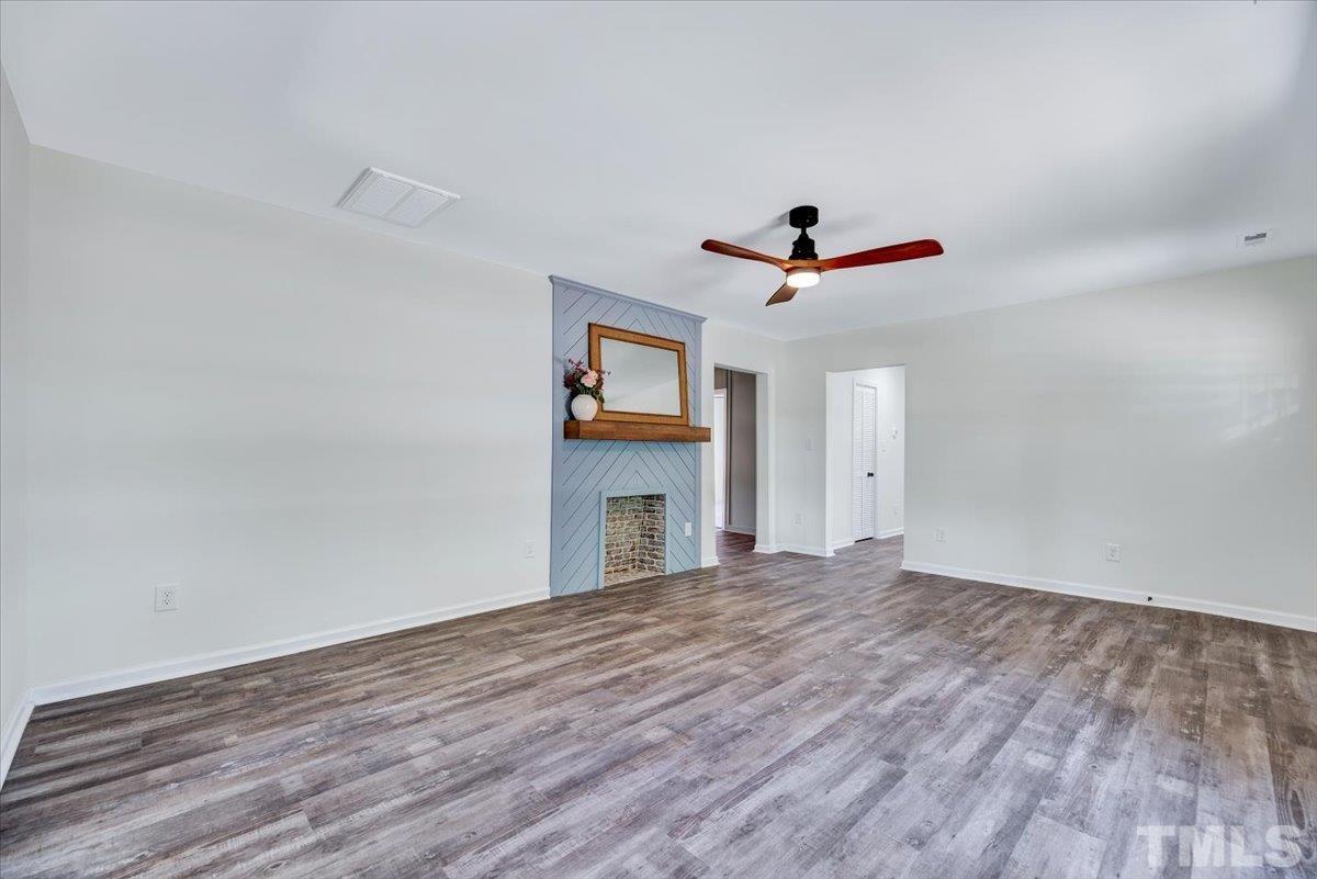 962 Laurel Mill-Centerville Road Louisburg, NC 27549 - Photo 6 of 36 a view of a livingroom with a ceiling fan and a ceiling fan