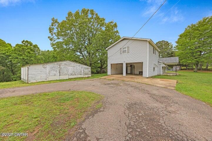 5060 Enville Road Henderson, TN 38340 - Photo 2 of 17 a front view of house with yard and trees