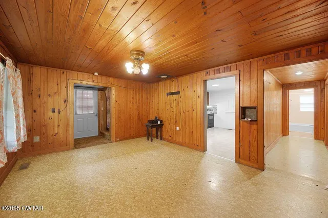a view of empty room with wooden walls