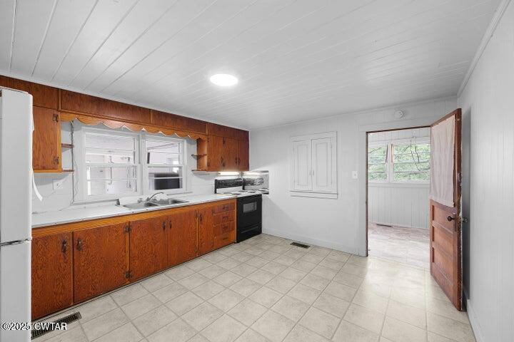 5060 Enville Road Henderson, TN 38340 - Photo 7 of 17 a large kitchen with stainless steel appliances granite countertop a refrigerator and a sink