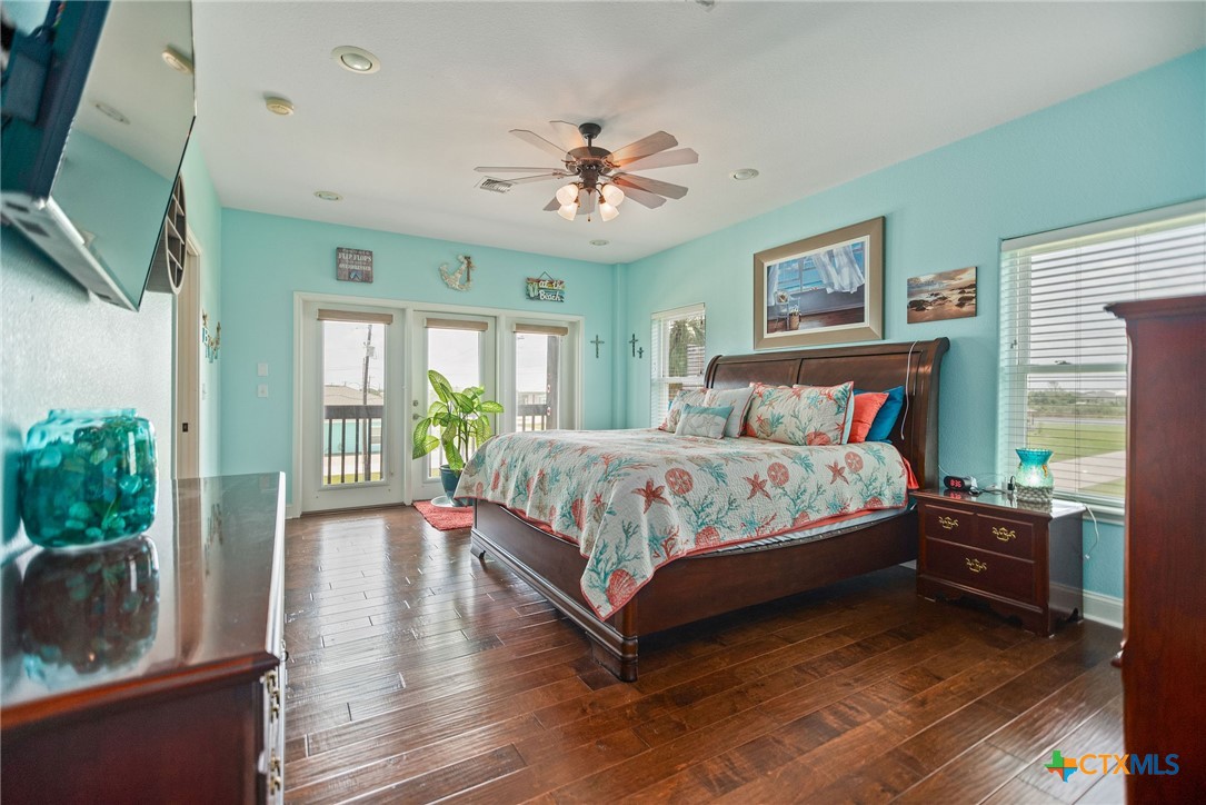 23 Macey Street Port O'Connor, TX 77982 - Photo 36 of 47 a bedroom with a bed and a large window