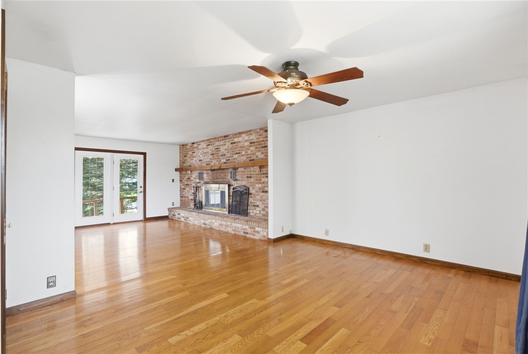 6711 Hamilton-Middletown Road Franklin, OH 45005 - Photo 7 of 49 This living area features a classic brick fireplace and elegant hardwood flooring.