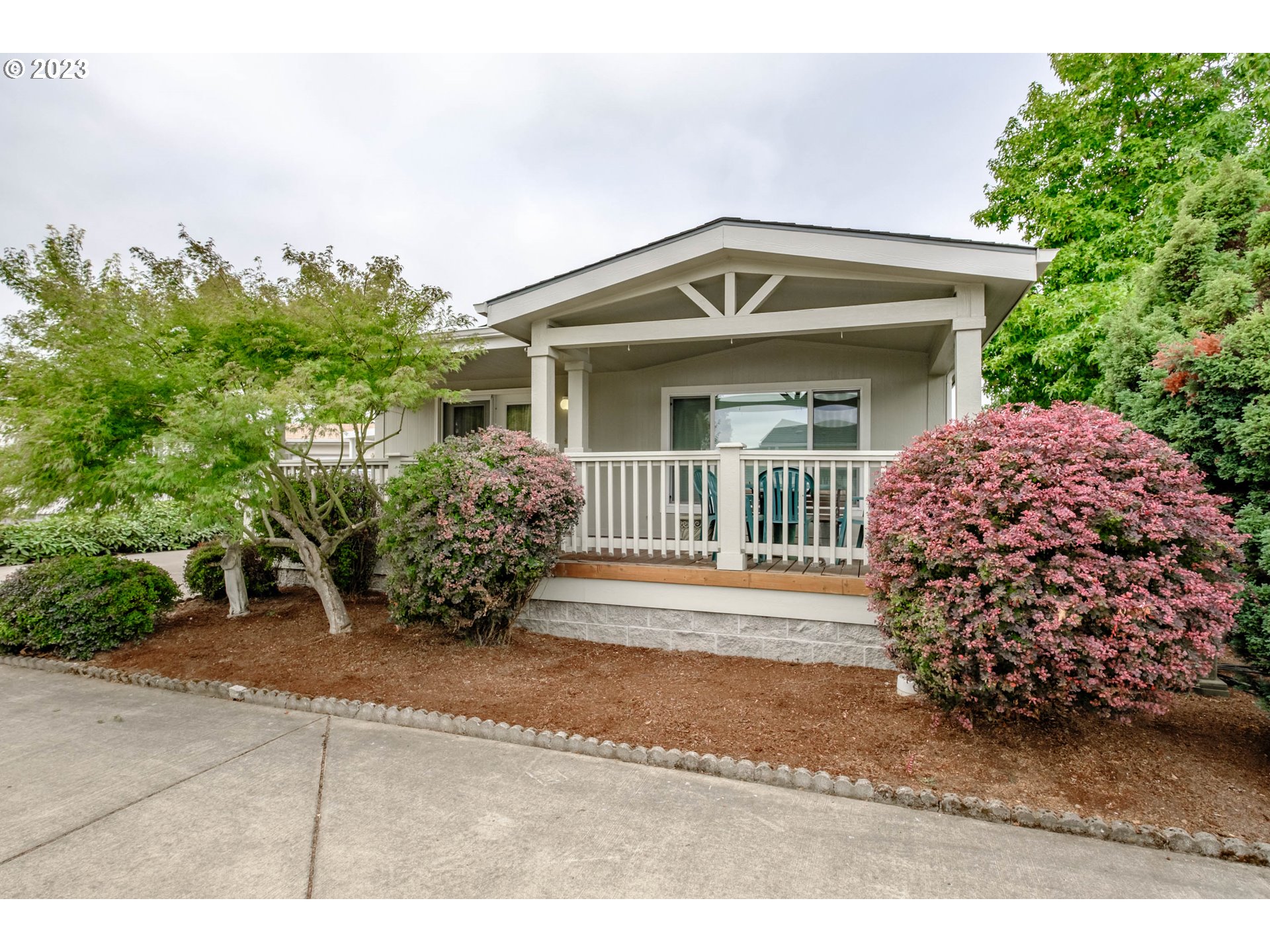 2434 Maia Loop Springfield, OR 97477 - Photo 1 of 36 a front view of a house with a garden