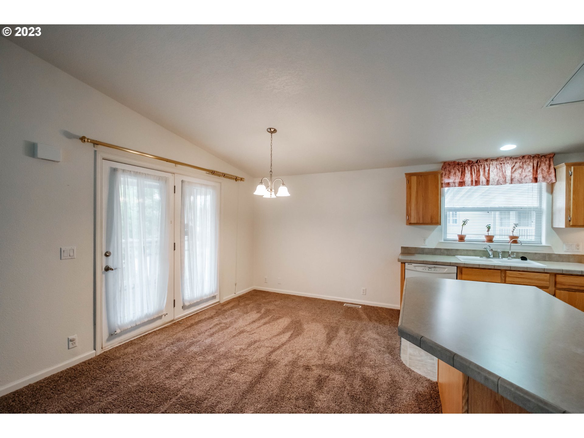 2434 Maia Loop Springfield, OR 97477 - Photo 11 of 36 a view of a kitchen with a sink and a large window