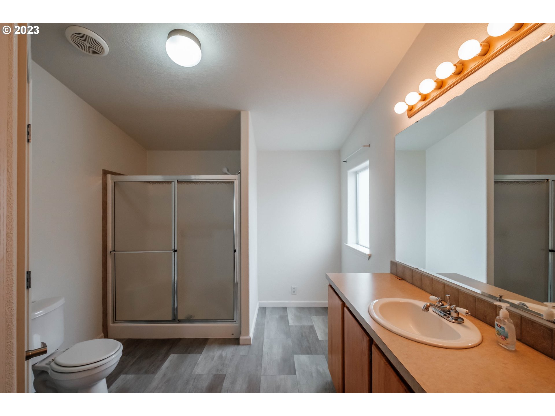 2434 Maia Loop Springfield, OR 97477 - Photo 24 of 36 a bathroom with a granite countertop sink a toilet and a mirror