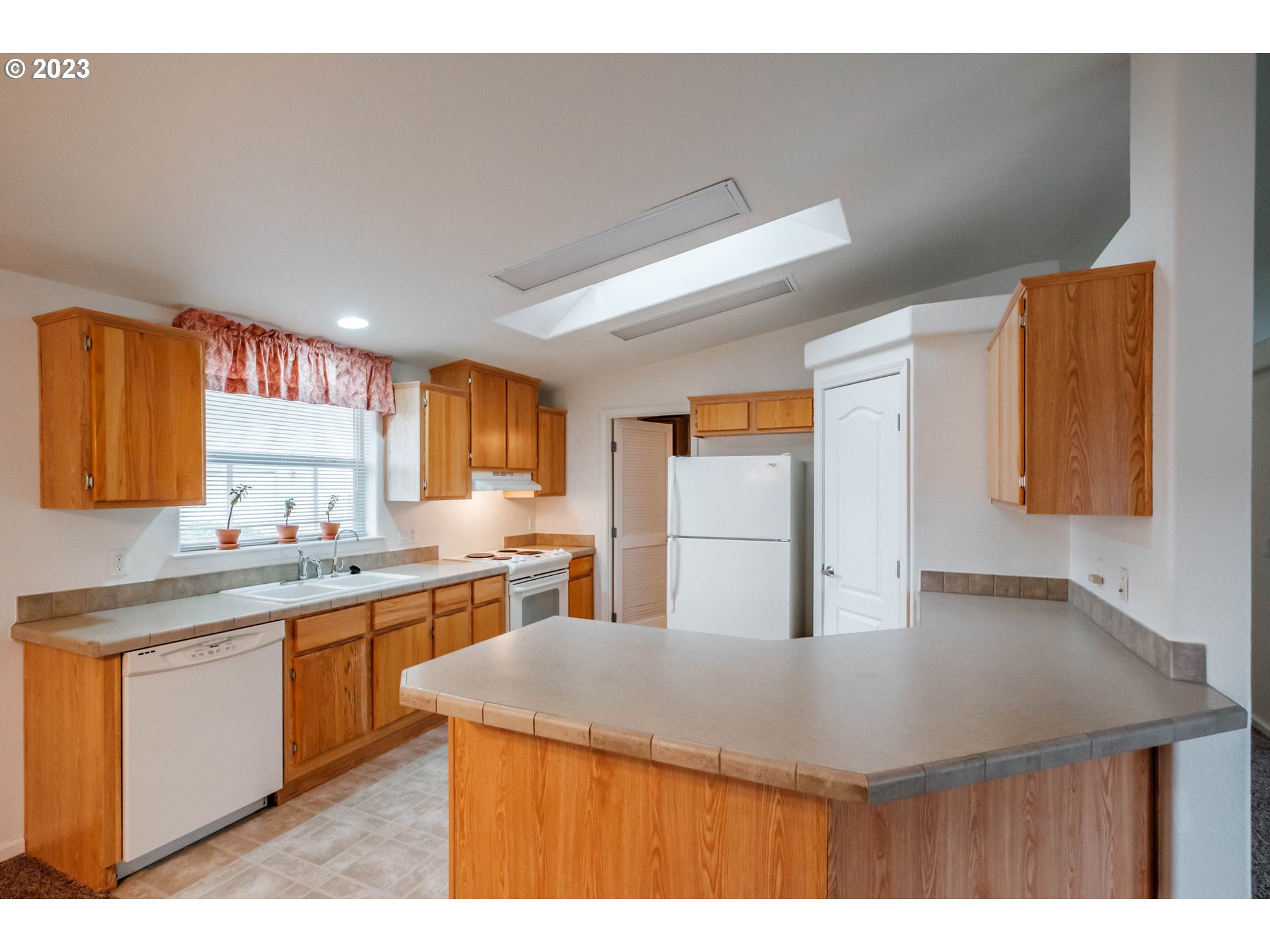 2434 Maia Loop Springfield, OR 97477 - Photo 7 of 36 a kitchen with a sink a stove and chairs