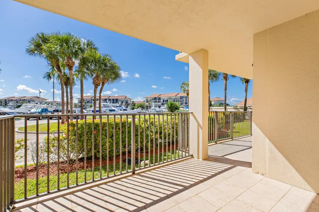 a view of a balcony with floor to ceiling window and wooden fence