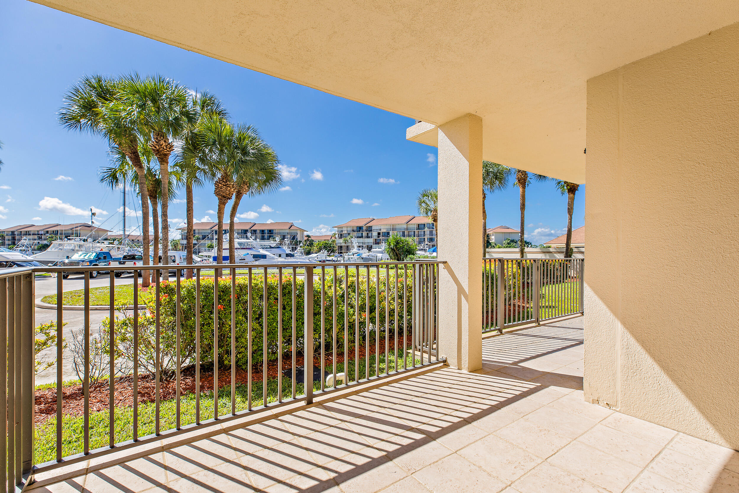 1501 Marina Isle Way, Unit 101 Jupiter, FL 33477 - Photo 18 of 25 a view of a balcony with floor to ceiling window and wooden fence