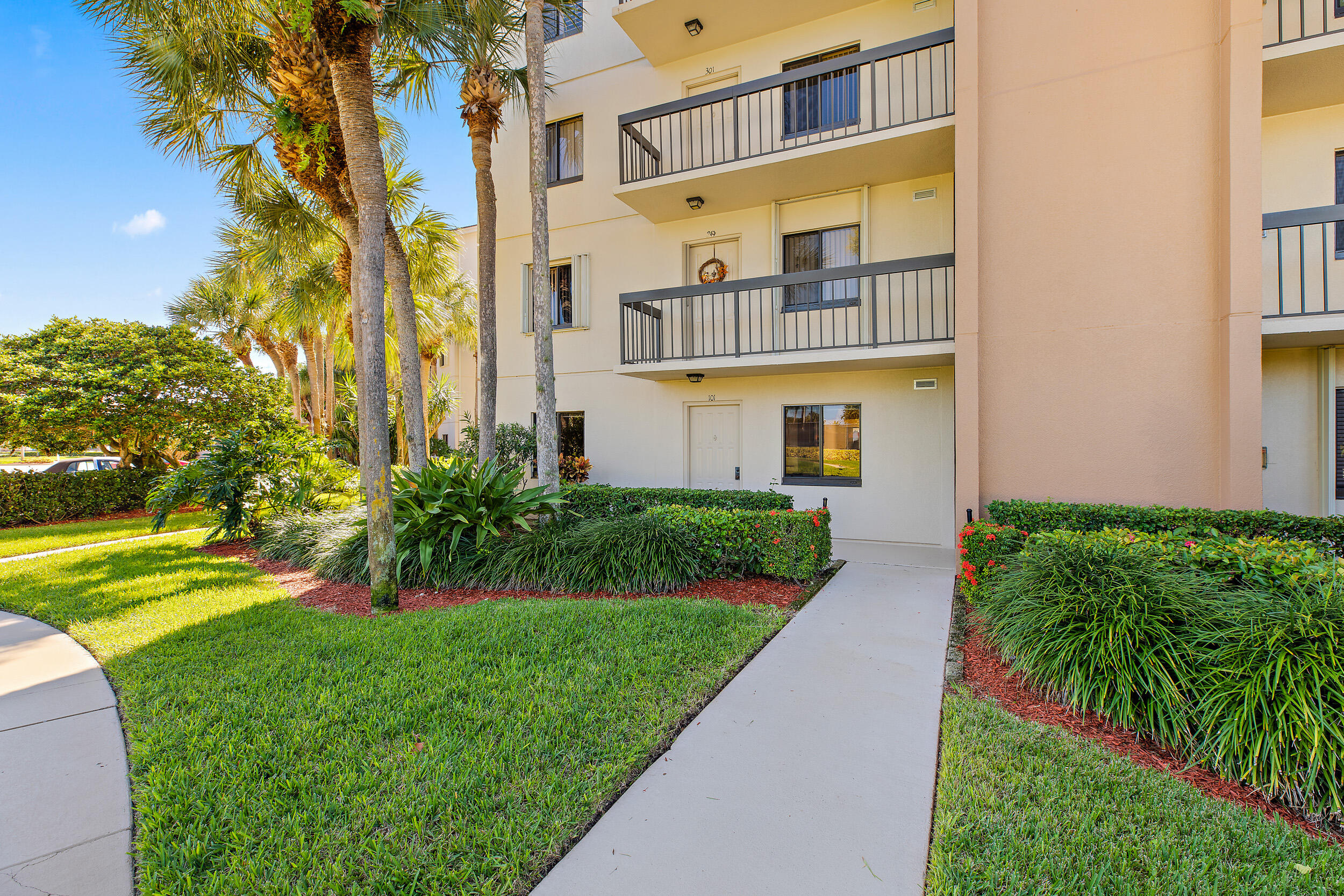 1501 Marina Isle Way, Unit 101 Jupiter, FL 33477 - Photo 20 of 25 a front view of a house with a yard