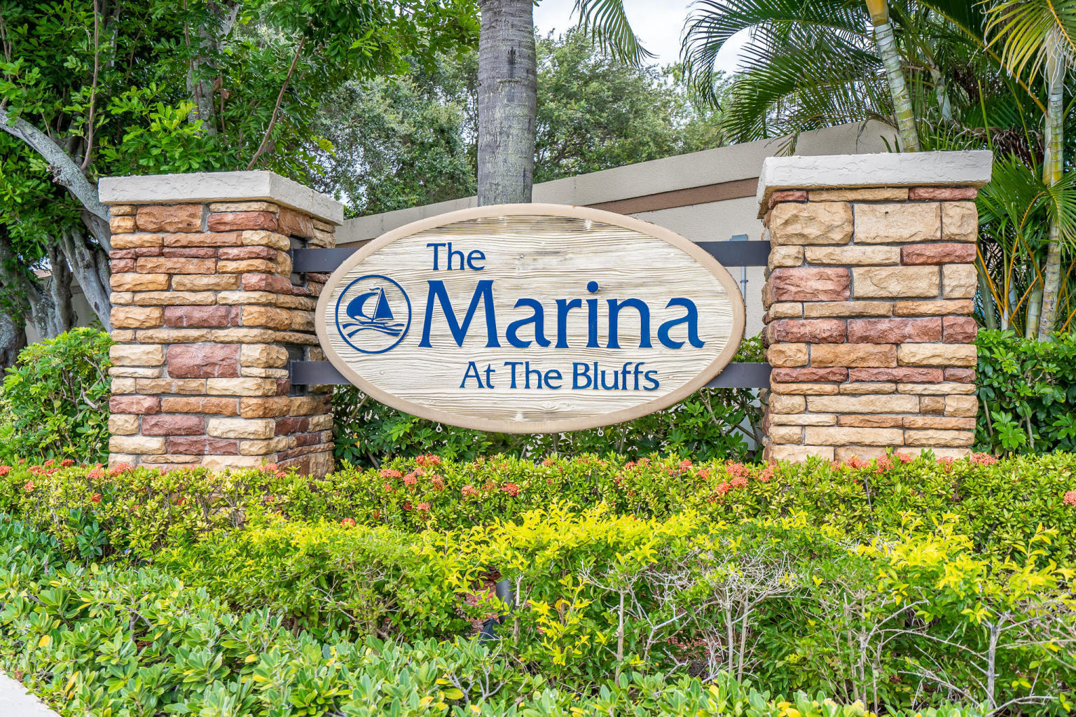 1501 Marina Isle Way, Unit 101 Jupiter, FL 33477 - Photo 21 of 25 a sign board with a house and trees in the background