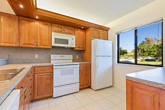 a kitchen with appliances cabinets and a sink