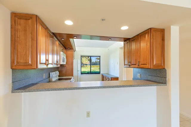 a kitchen with granite countertop sink and cabinets