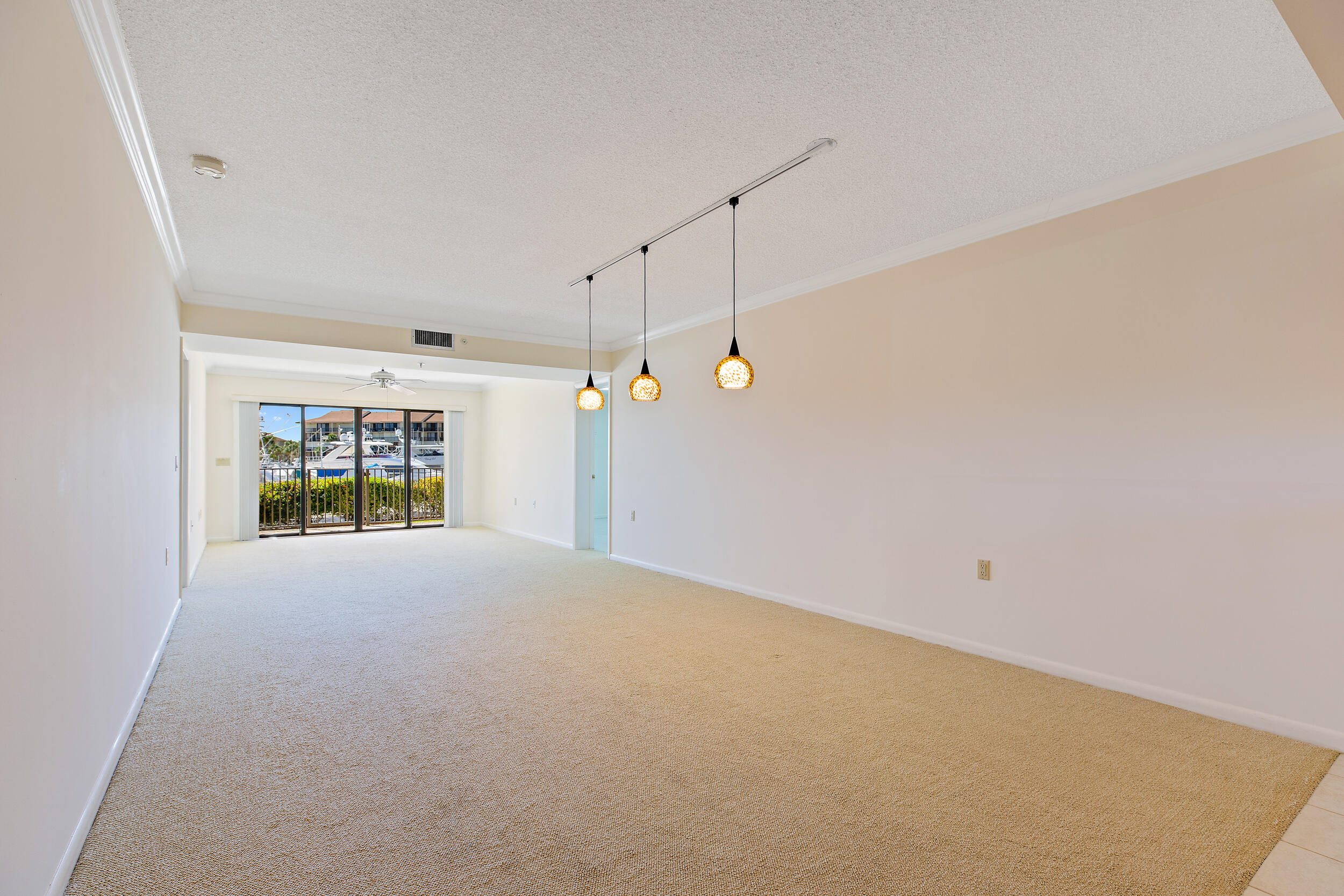 1501 Marina Isle Way, Unit 101 Jupiter, FL 33477 - Photo 8 of 25 a view of an empty room with a window