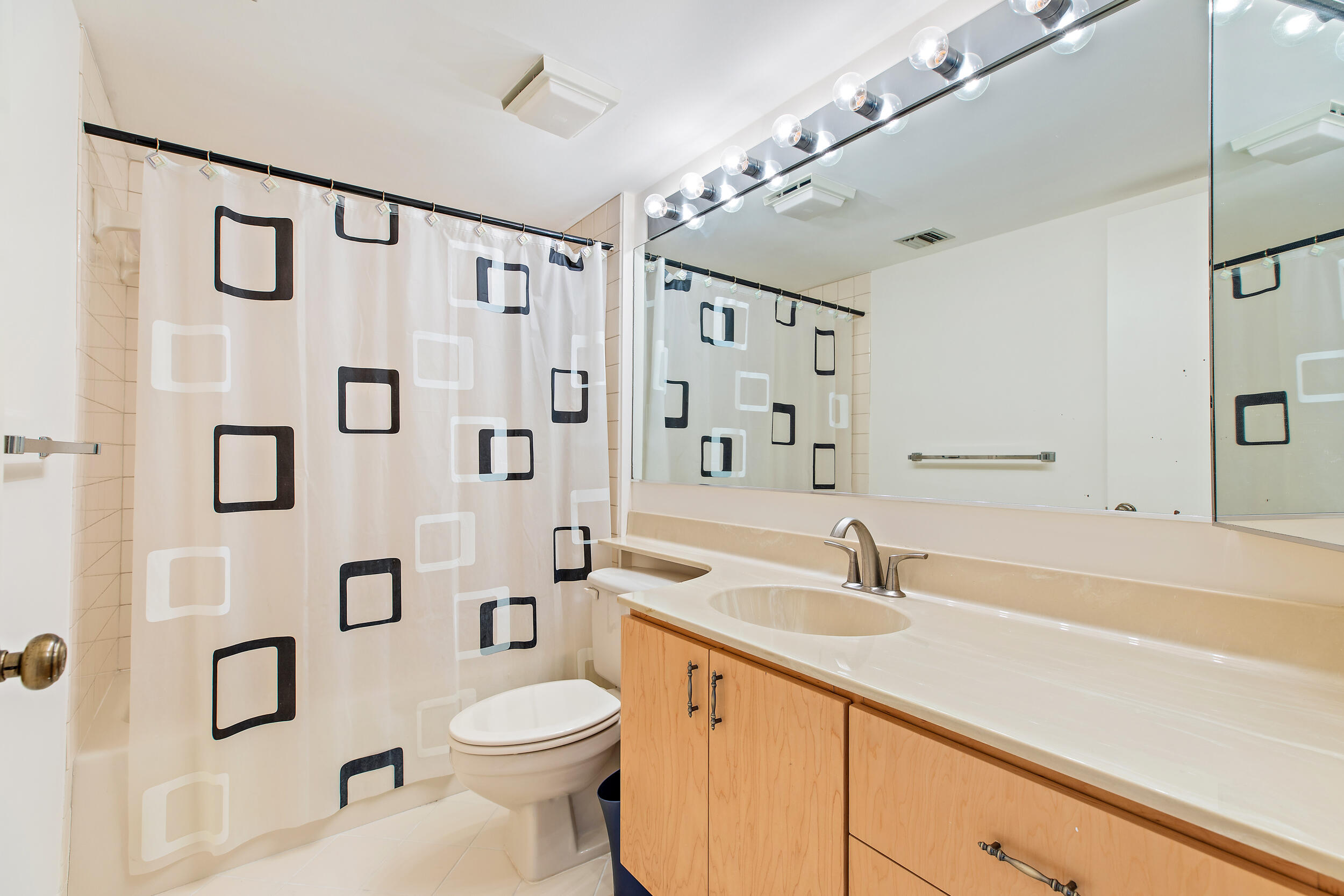 1501 Marina Isle Way, Unit 101 Jupiter, FL 33477 - Photo 10 of 25 a bathroom with a sink a toilet and shower