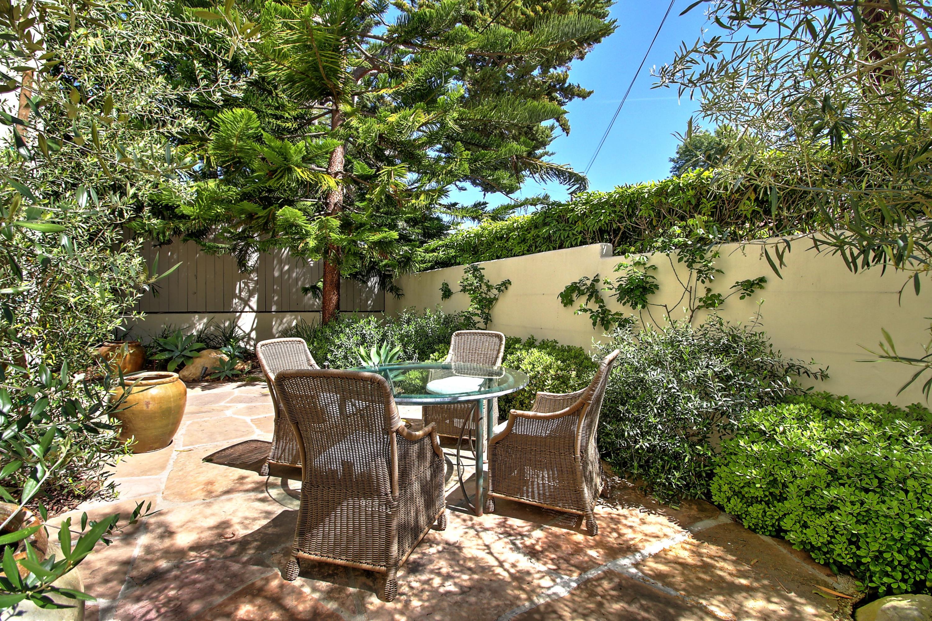 71 Olive Mill Road Montecito, CA 93108 - Photo 18 of 22 a view of a table and chairs in back yard of a house