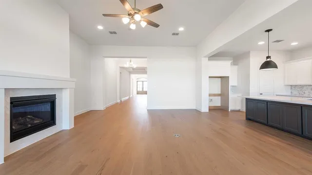 a view of a kitchen with a sink and a fireplace
