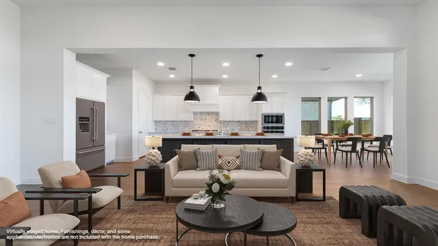 a living room with furniture and kitchen view
