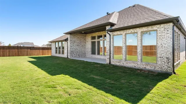 a front view of a house with a garden and yard