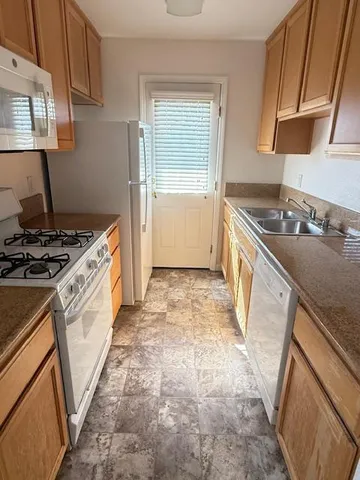 a kitchen with a stove a sink and a refrigerator