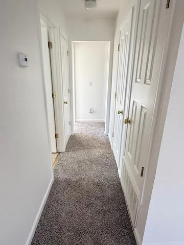 a view of a hallway with a white walls