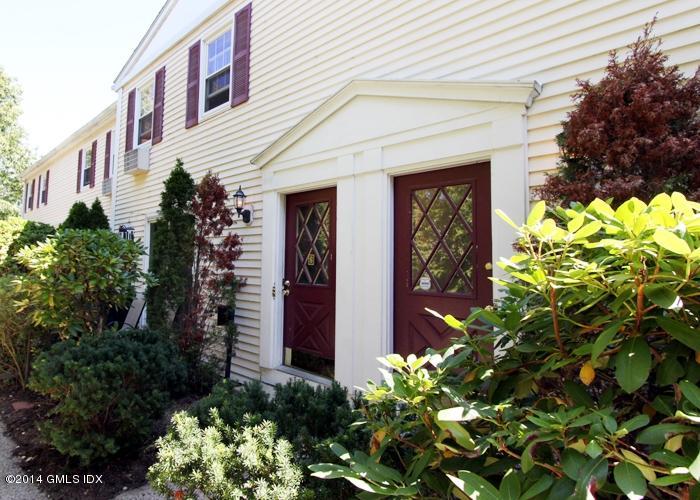 a front view of a house with lots of flower