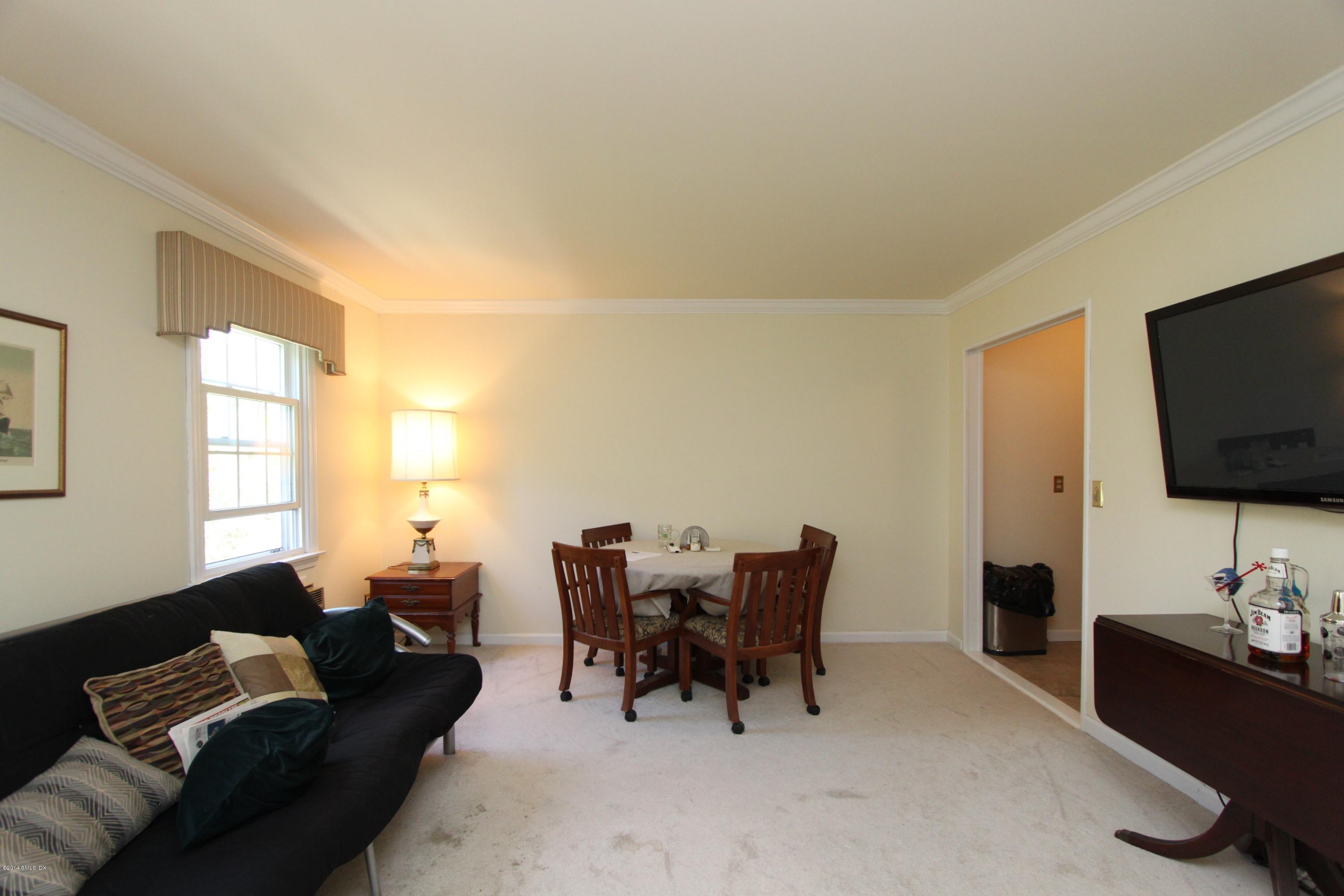 9 Weaver Street, Unit 9 Greenwich, CT 06831 - Photo 2 of 6 a living room with furniture and a flat screen tv