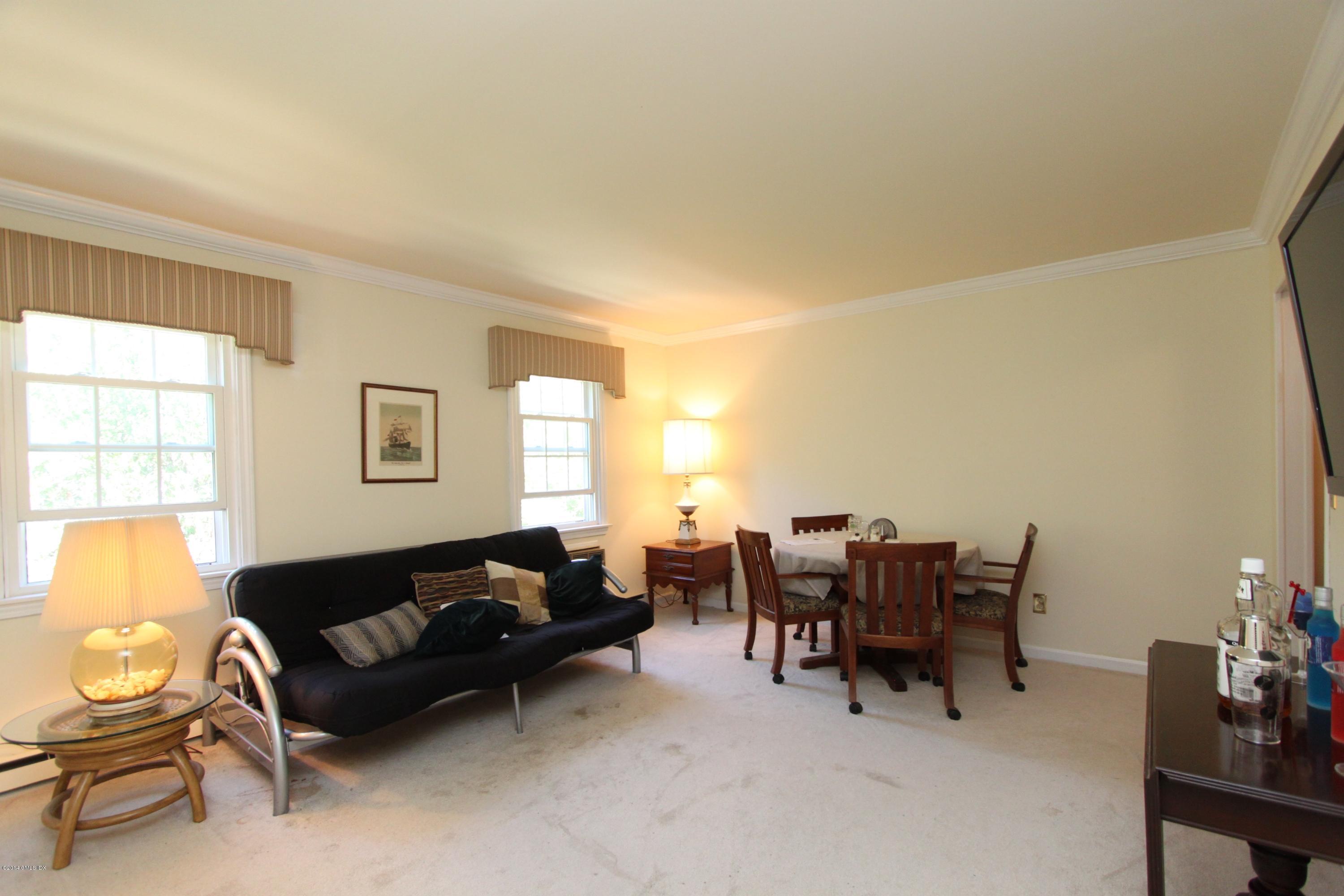 9 Weaver Street, Unit 9 Greenwich, CT 06831 - Photo 3 of 6 a living room with furniture and a large window