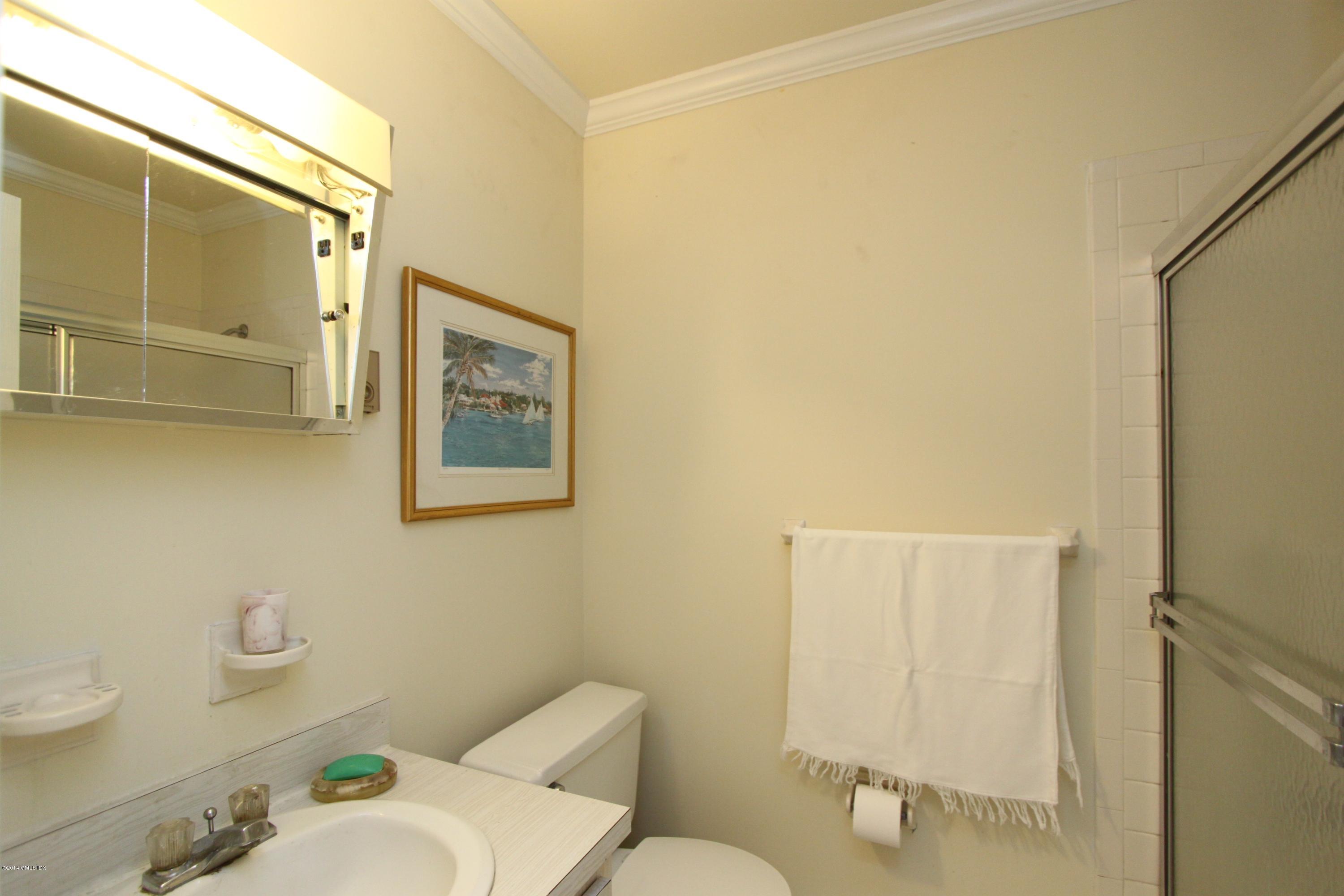 9 Weaver Street, Unit 9 Greenwich, CT 06831 - Photo 6 of 6 a white toilet sitting next to a bathroom sink