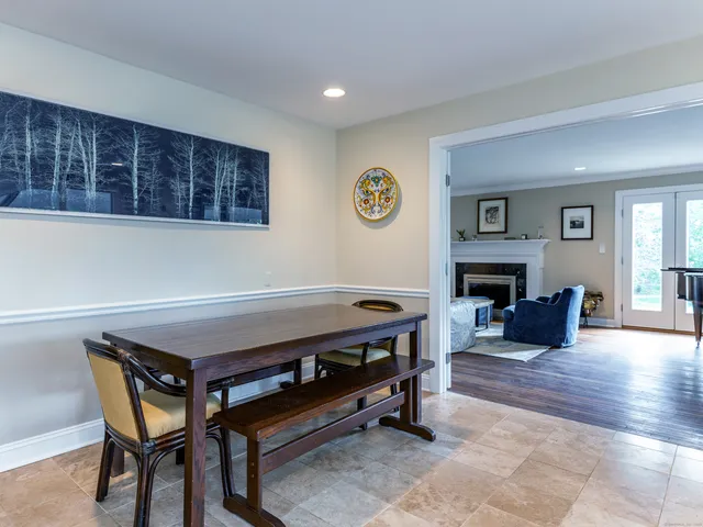 a living room with furniture a pool table and a fireplace