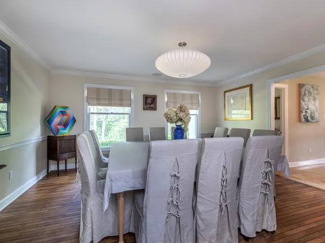a view of a dining room with furniture and a chandelier