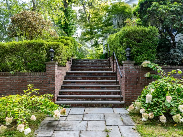 a backyard of a house with lots of green space and lake view