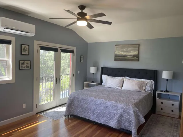 a spacious bedroom with a large bed and a window