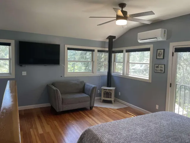 a bedroom with furniture and a flat screen tv
