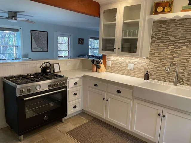 a kitchen with stainless steel appliances a stove sink and cabinets