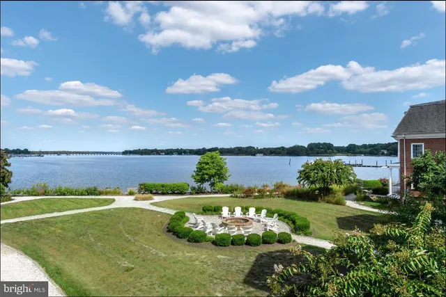 a view of a lake with houses in back