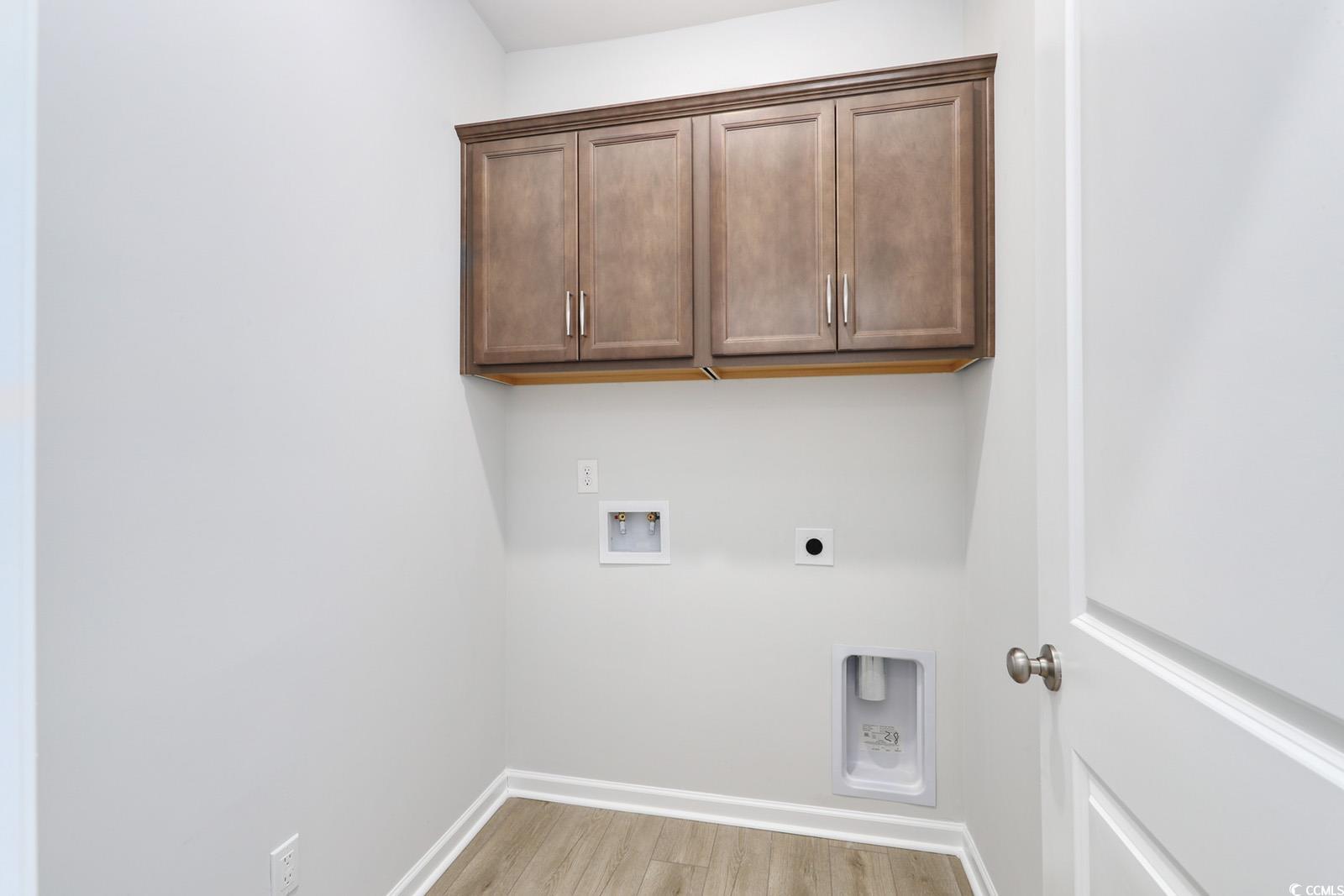 311 Garden Grove Street Conway, SC 29526 - Photo 23 of 27 Washroom featuring light wood-style floors, electric dryer hookup, hookup for a washing machine, and cabinet space