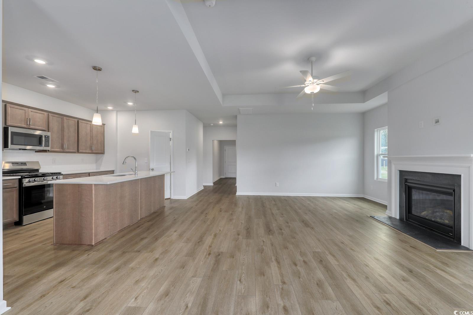 311 Garden Grove Street Conway, SC 29526 - Photo 7 of 27 Kitchen featuring stainless steel appliances, pendant lighting, an island with sink, light wood finished floors, and recessed lighting