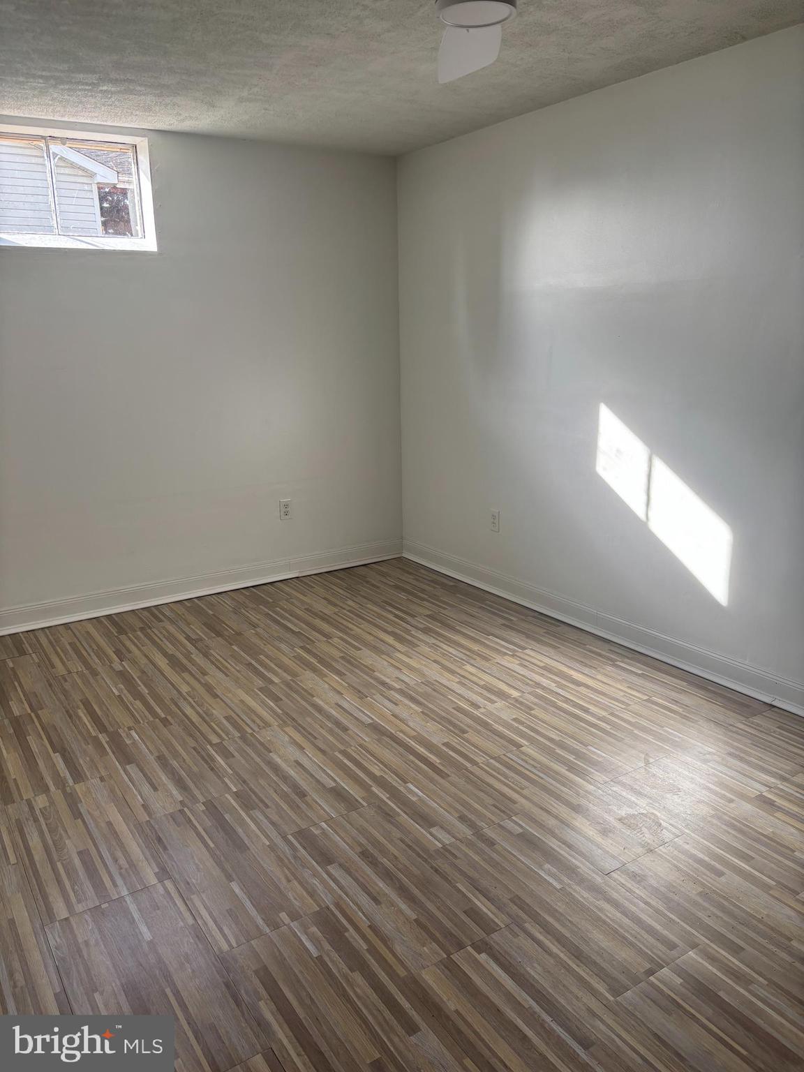 606 Gray Mt Circle Elkton, MD 21921 - Photo 13 of 13 an empty room with wooden floor and windows