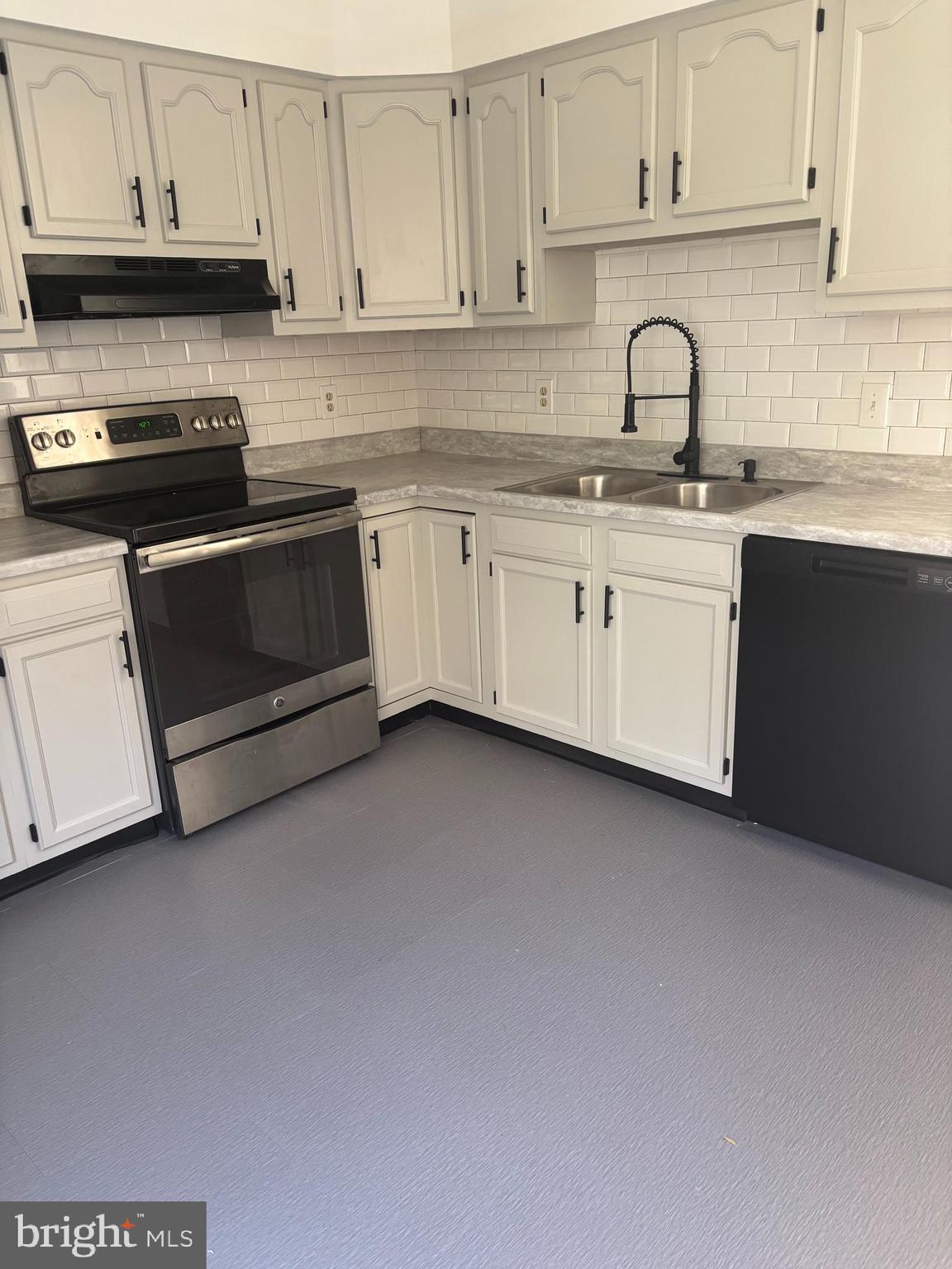 606 Gray Mt Circle Elkton, MD 21921 - Photo 4 of 13 a kitchen with stainless steel appliances granite countertop a sink a stove and cabinets