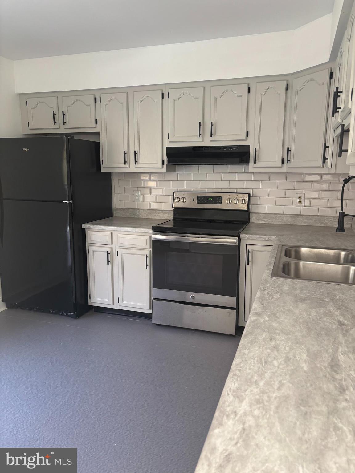 606 Gray Mt Circle Elkton, MD 21921 - Photo 5 of 13 a kitchen with stainless steel appliances granite countertop a stove a sink and white cabinets