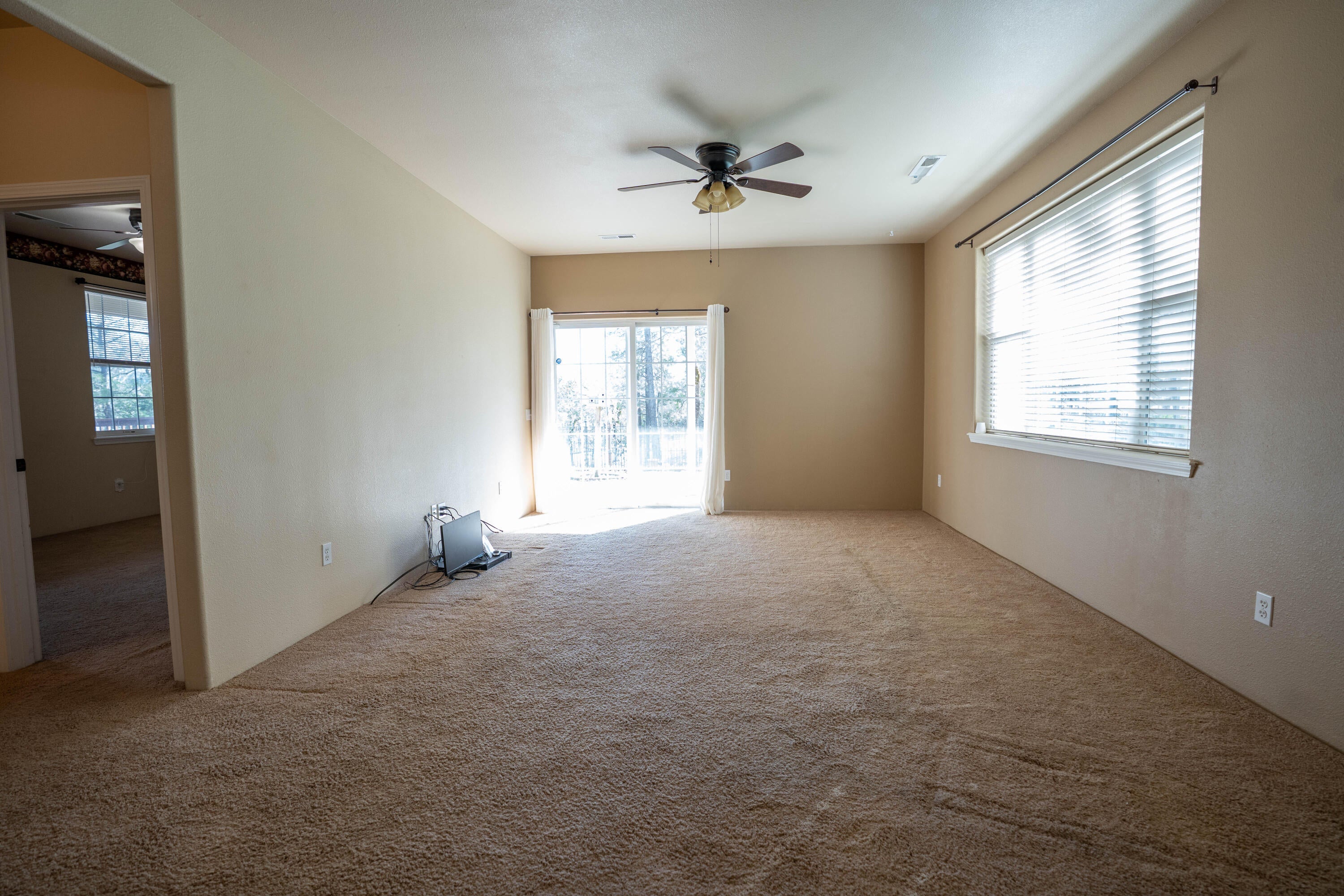 2080 Swingle Road Trail, OR 97541 - Photo 27 of 52 Secondary family room with patio access and additional bedrooms off the hallway.